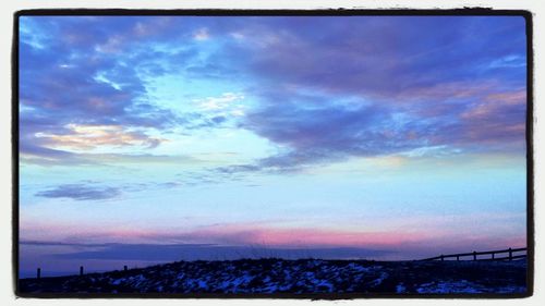 Scenic view of landscape against cloudy sky