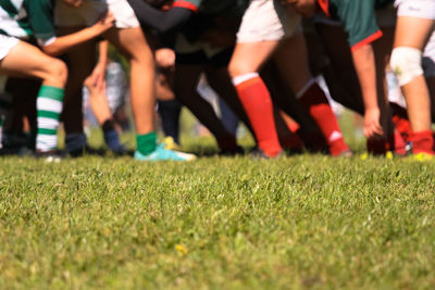 Low section of people relaxing on field