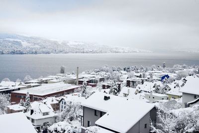 High angle view of snow covered buildings against sky