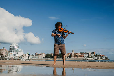 Man standing by sea against sky