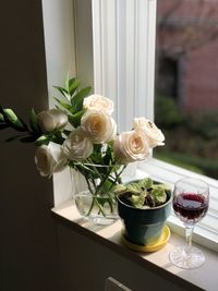 Close-up of white roses in vase on table