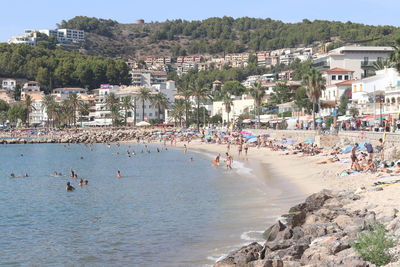 Group of people on beach in city