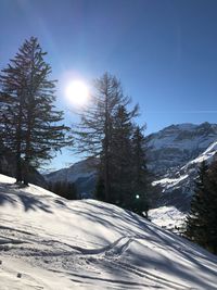 Scenic view of snow covered mountains against sky