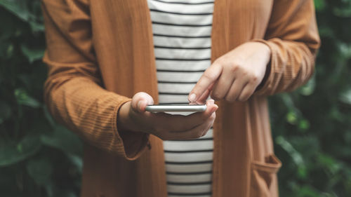Close-up of man holding mobile phone