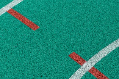 High angle view of arrow symbol on grass