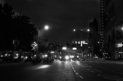 Illuminated city street at night