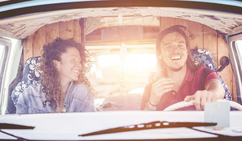 Happy man with woman driving van