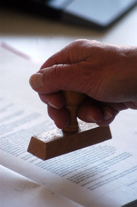 Close-up of hand holding book