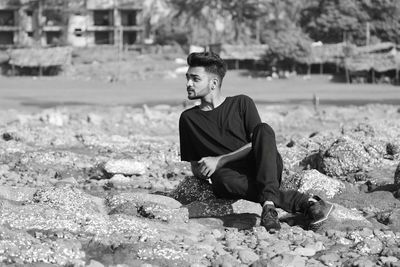 Young man sitting outdoors