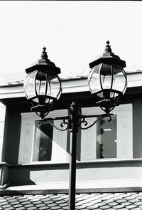 Low angle view of street light against building