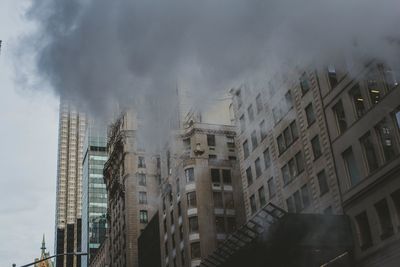 Smoke emitting from chimney against sky