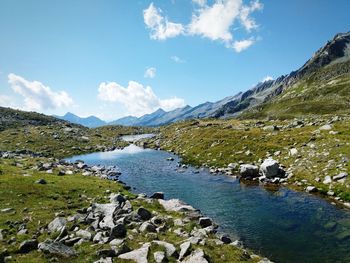 Scenic view of lake and mountains against sky