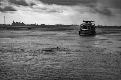 Boat sailing on sea against sky