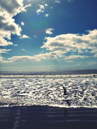 Scenic view of sea against cloudy sky