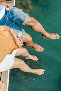 Midsection of couple in water