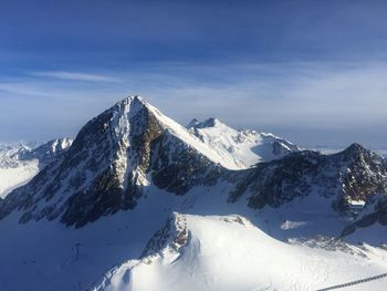 Scenic view of snow covered mountains against sky