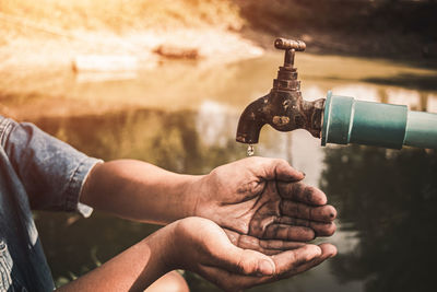 Close-up of man working in water