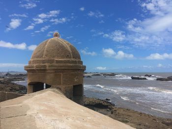 Built structure on beach against sky
