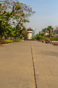 Surface level of footpath by building against sky