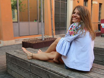 Portrait of smiling woman sitting outdoors