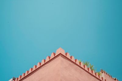 Low angle view of building against clear blue sky