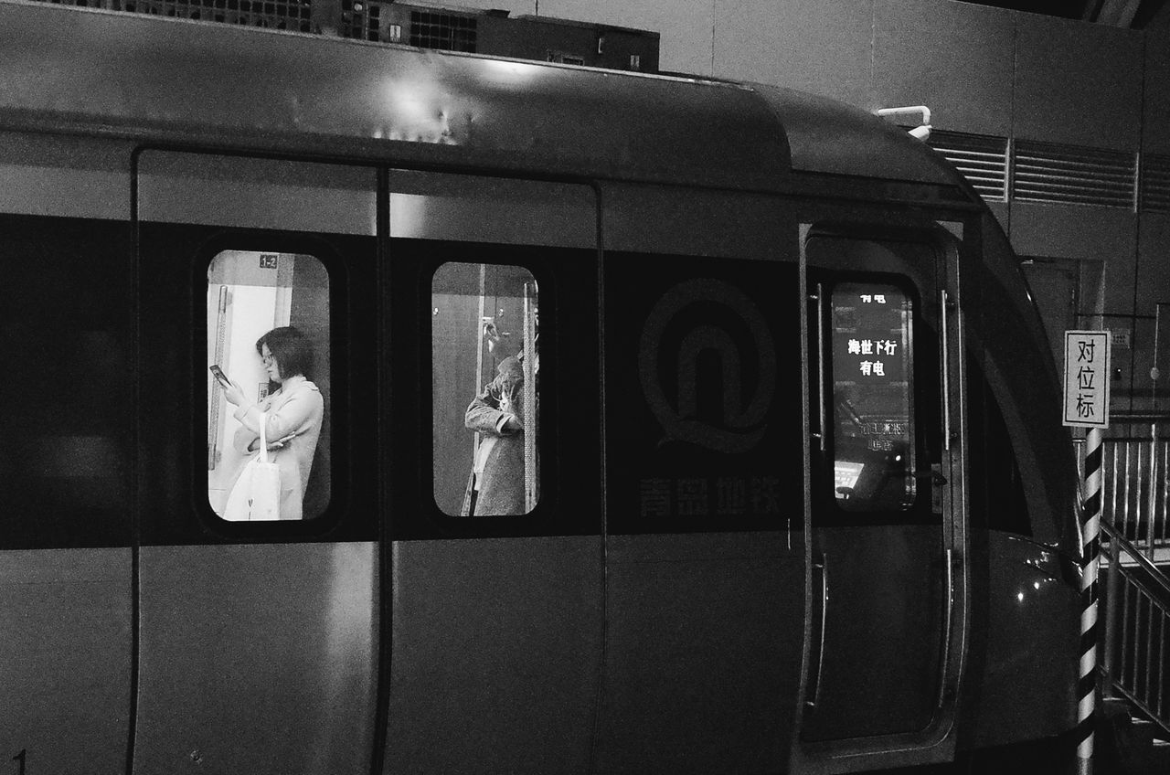 technology, telephone, communication, public transportation, illuminated, reflection, rail transportation, text, connection, transportation, indoors, mode of transportation, pay phone, real people, women, night, subway train