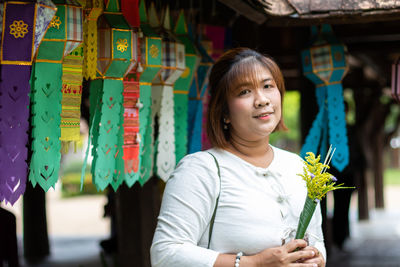 Portrait of a smiling young woman standing outdoors