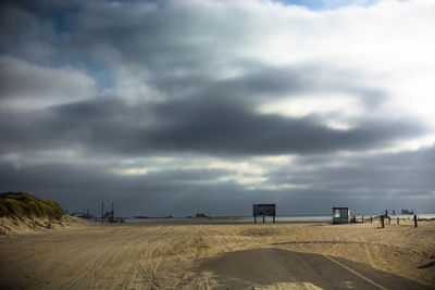 Scenic view of field against storm clouds