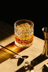 Close-up of glass with bourbon whiskey on table