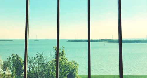 Scenic view of sea against sky seen through window