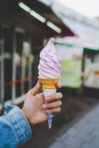 Cropped image of hand holding ice cream