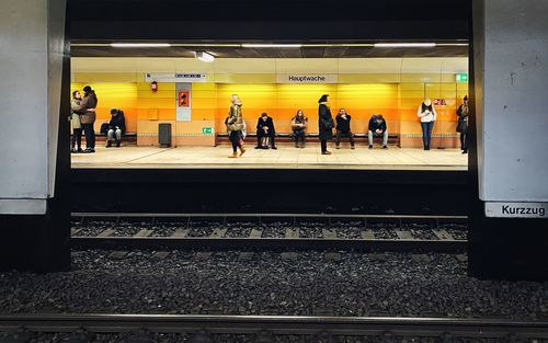People waiting train at railroad station platform