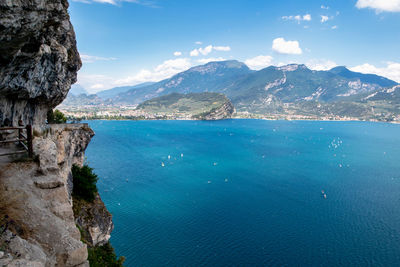 Scenic view of sea and mountains against sky