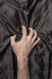 Close-up of woman hand on bed