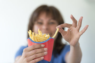 Close-up of woman holding french fries