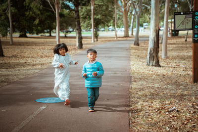 Rear view of woman walking on field