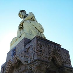 Low angle view of statue against blue sky