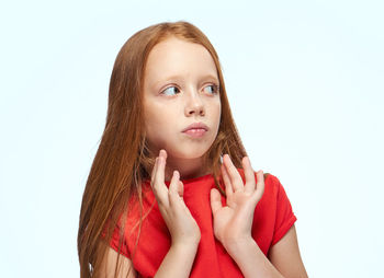 Portrait of young woman against white background