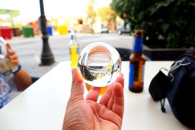 Close-up of a man holding crystal ball