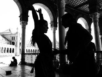 Silhouette of people outside building