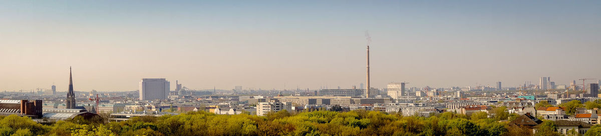 Panoramic view of city buildings against clear sky