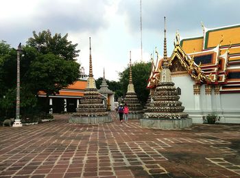 Man sitting on temple against sky