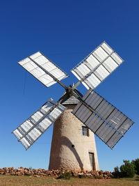 Low angle view of traditional windmill against sky