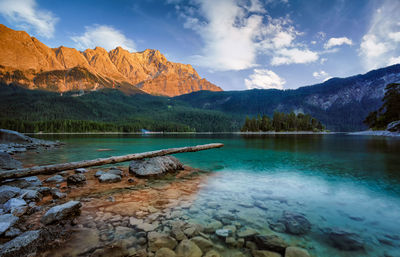 Scenic view of lake and mountains against sky