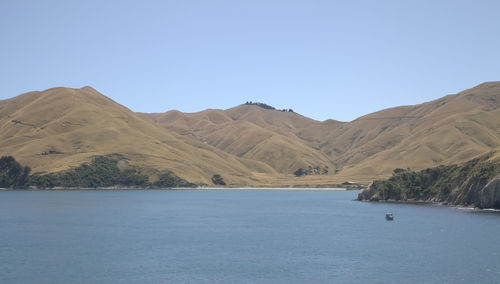 Scenic view of mountains against clear blue sky