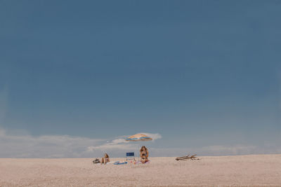 People on beach against sky