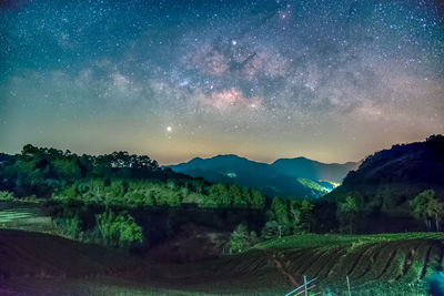 Scenic view of mountains against sky at night