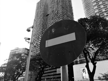 Low angle view of road sign against clear sky