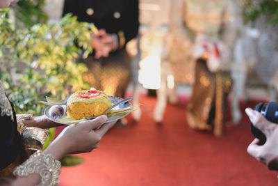 Cropped hand of woman holding wedding meal