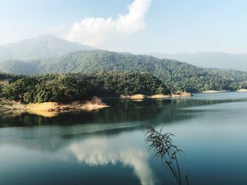 Scenic view of lake and mountains against sky